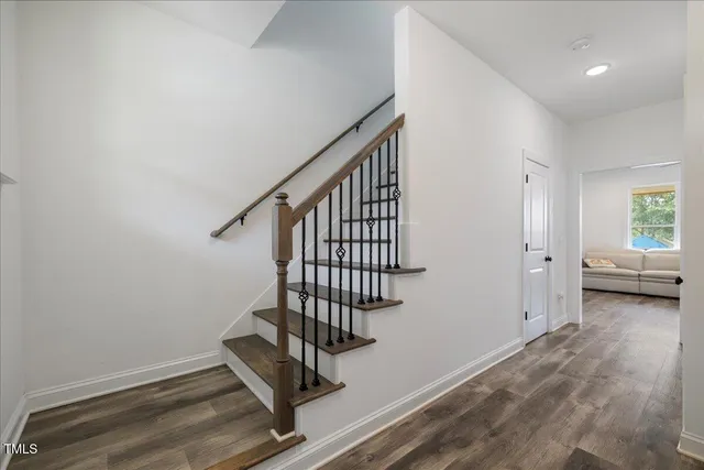 a view of a room with wooden floor and a potted plant