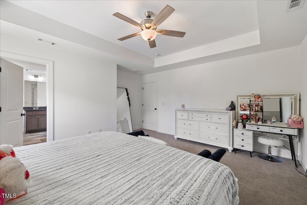 5421 West Old Spring Hope Road Spring Hope, NC 27882 - Photo 16 of 54 a bedroom with a bed and a chandelier