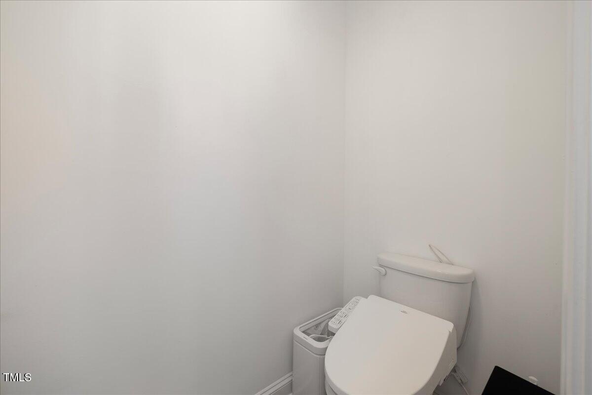 5421 West Old Spring Hope Road Spring Hope, NC 27882 - Photo 20 of 54 a white toilet sitting next to a white marble wall