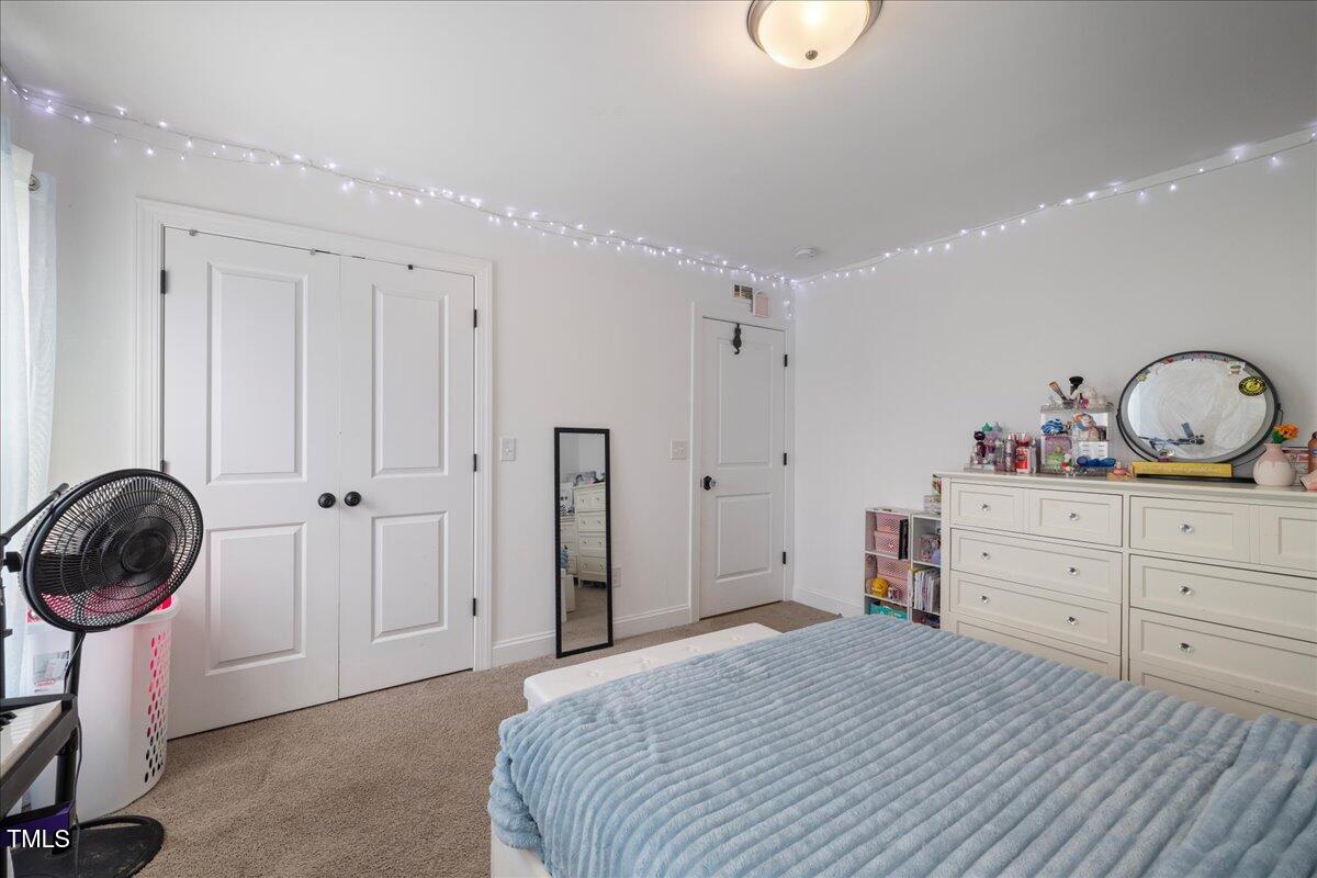 5421 West Old Spring Hope Road Spring Hope, NC 27882 - Photo 27 of 54 a bedroom with a bed and a cabinets