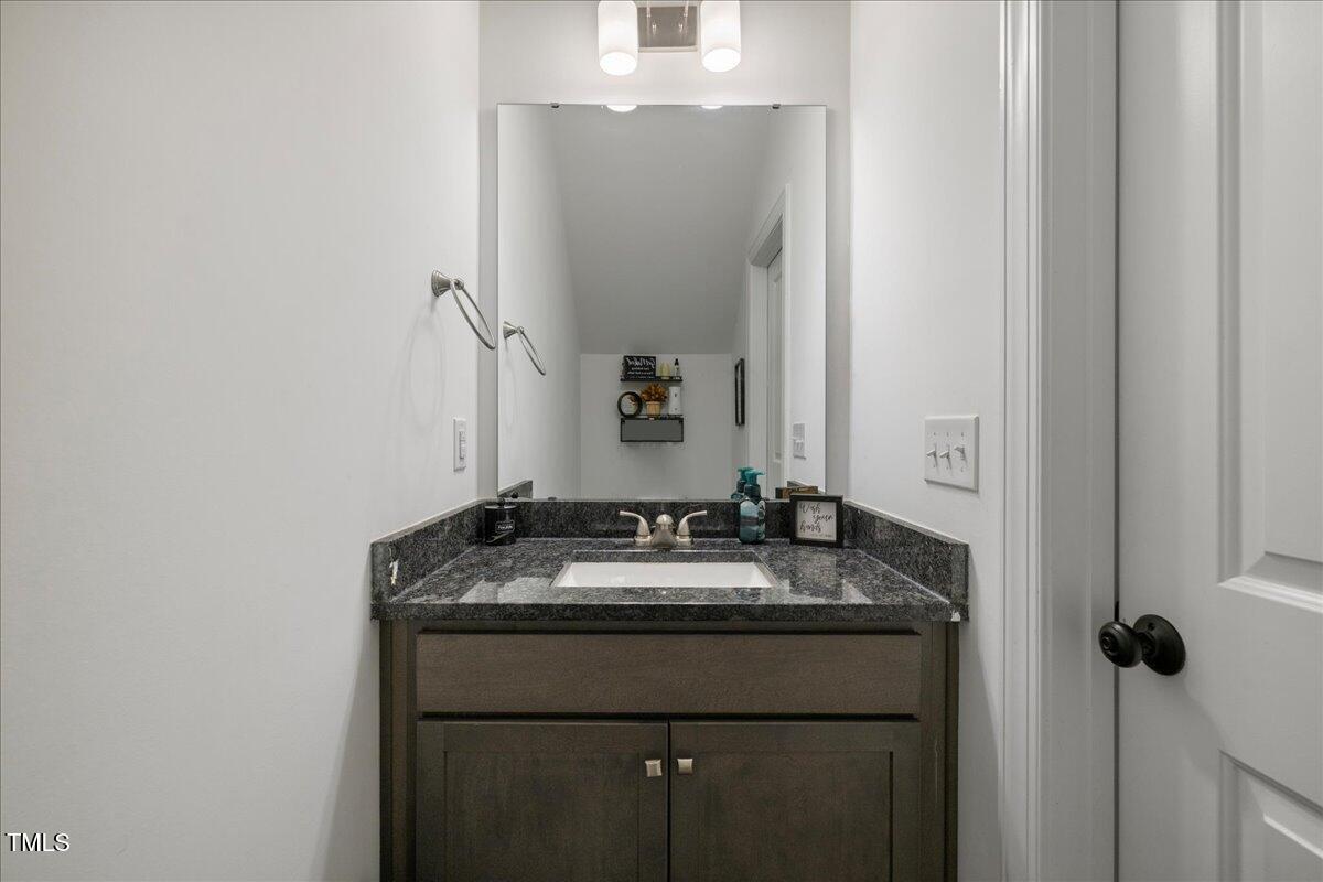 5421 West Old Spring Hope Road Spring Hope, NC 27882 - Photo 31 of 54 a bathroom with a granite countertop sink and a mirror