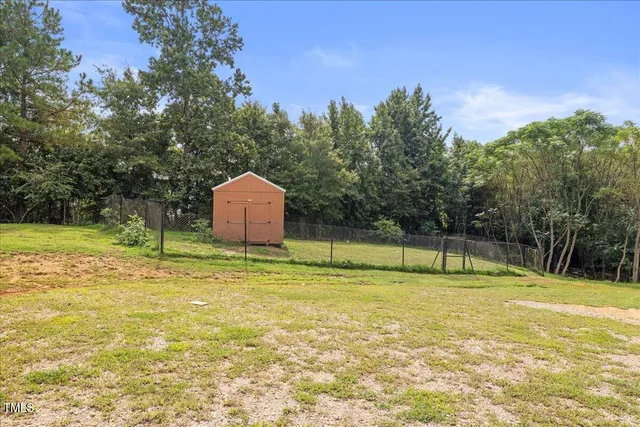a view of a swimming pool with a yard and palm trees