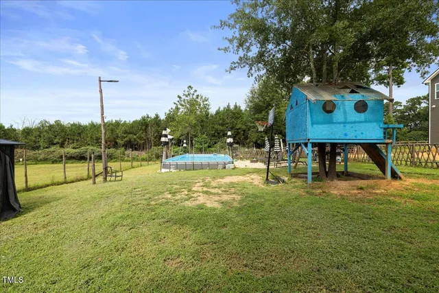 a view of a house with swimming pool and sitting area