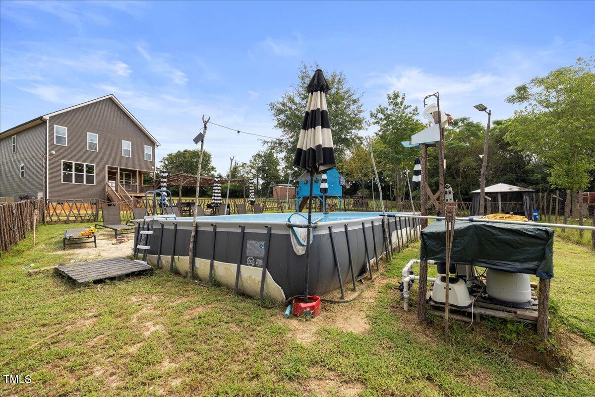 5421 West Old Spring Hope Road Spring Hope, NC 27882 - Photo 38 of 54 a view of a swimming pool with couches and a patio
