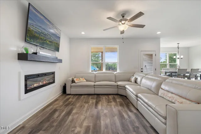 a living room with a couch and a ceiling fan