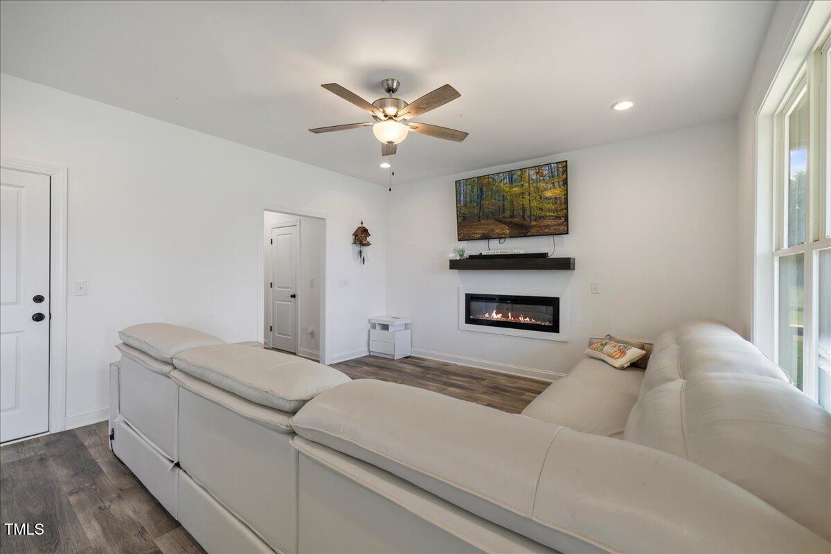 5421 West Old Spring Hope Road Spring Hope, NC 27882 - Photo 5 of 54 a living room with a couch and a ceiling fan