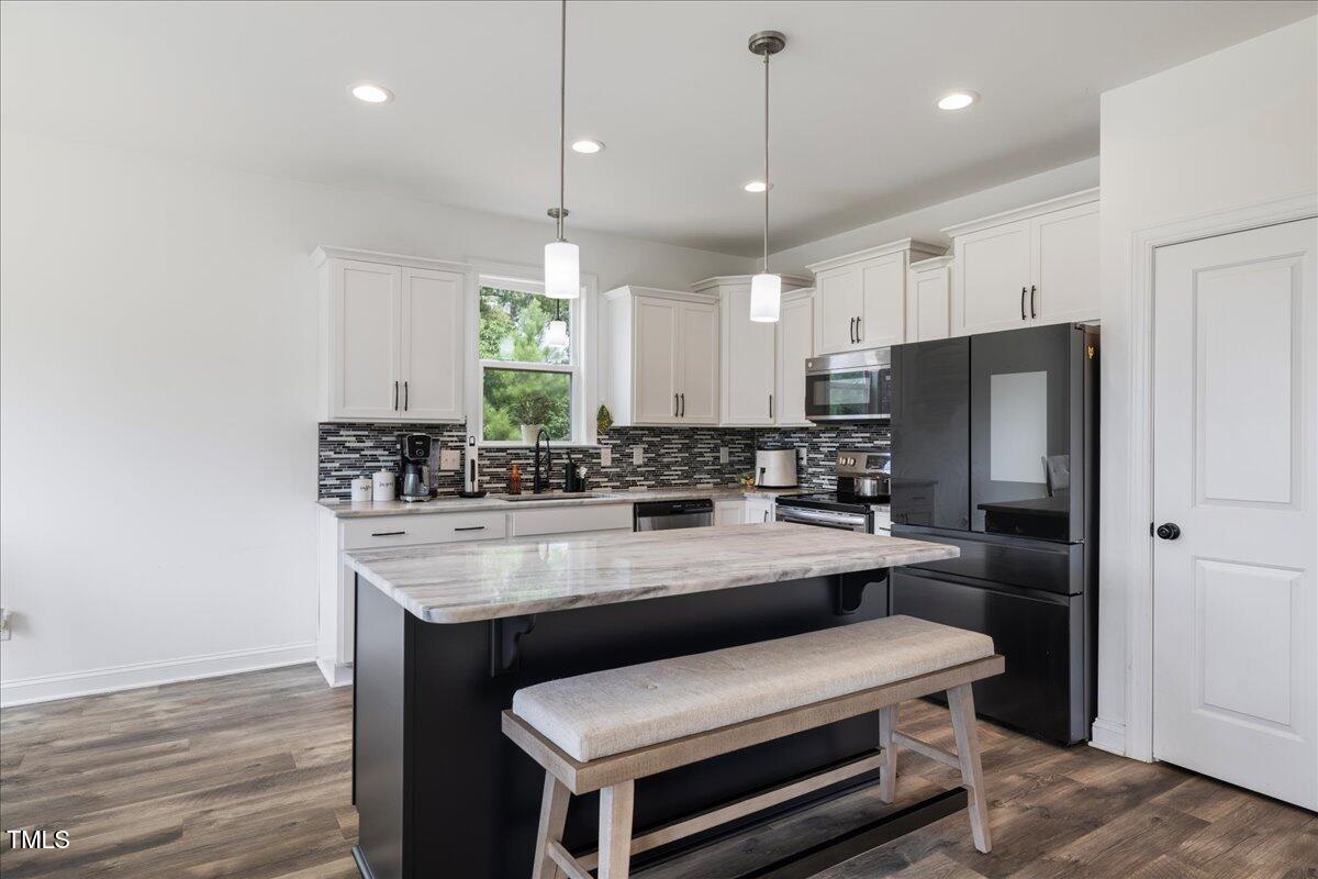5421 West Old Spring Hope Road Spring Hope, NC 27882 - Photo 6 of 54 a kitchen with kitchen island a sink stainless steel appliances and cabinets