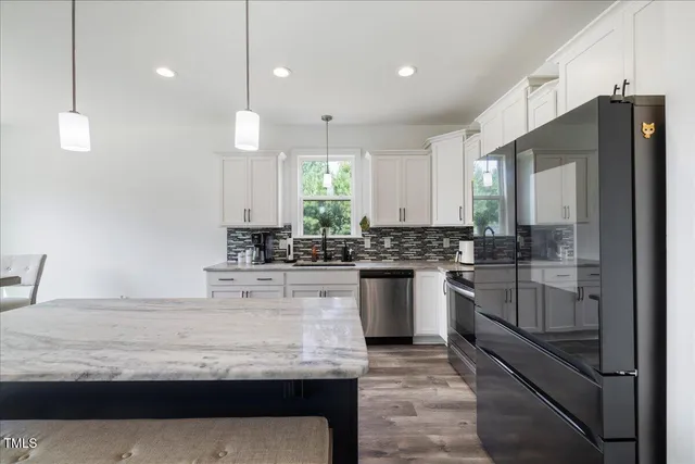 a kitchen with sink cabinets and wooden floor