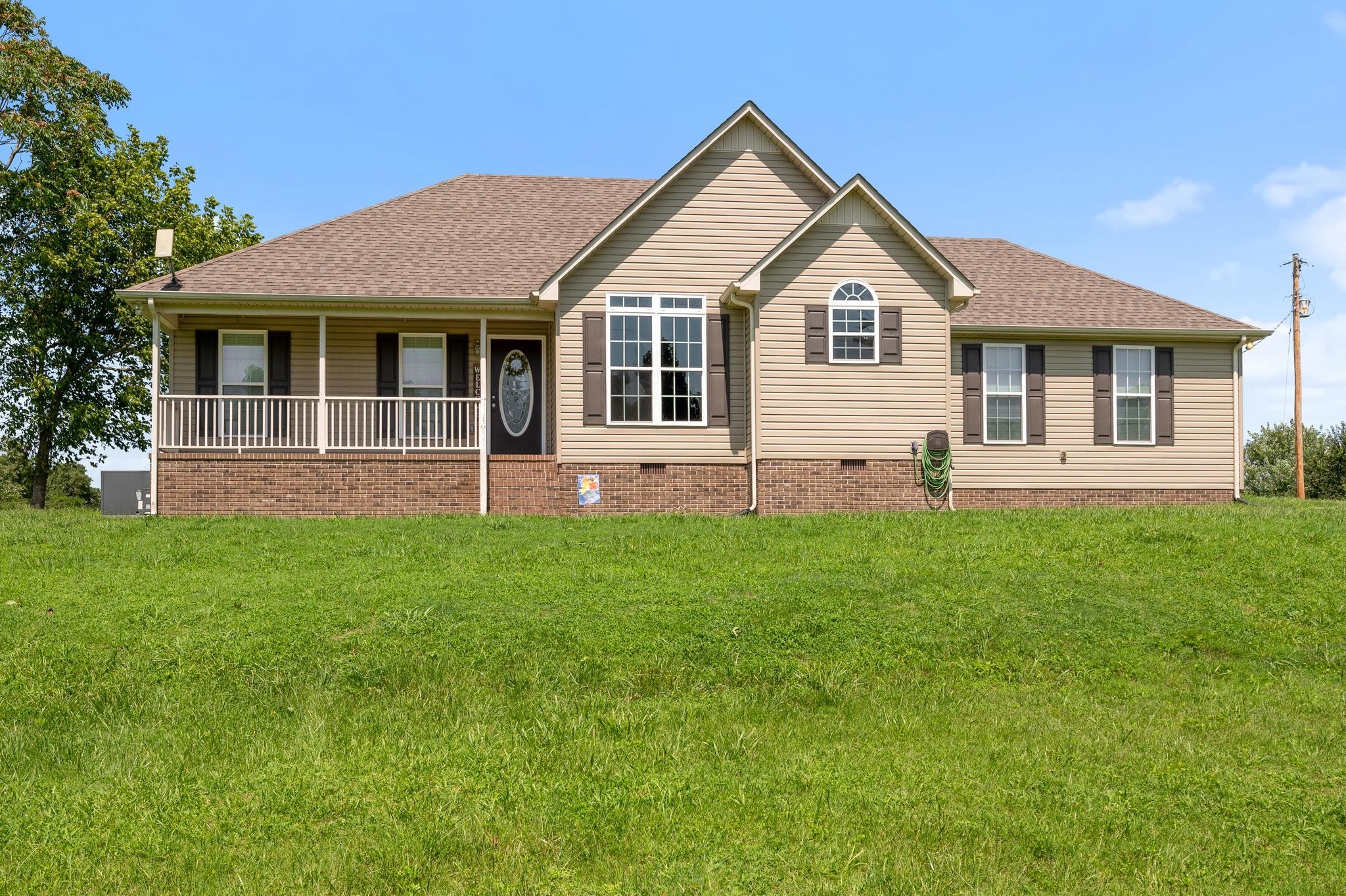 7040 Charity Road Petersburg, TN 37144 - Photo 1 of 36 a front view of a house with a yard and green space