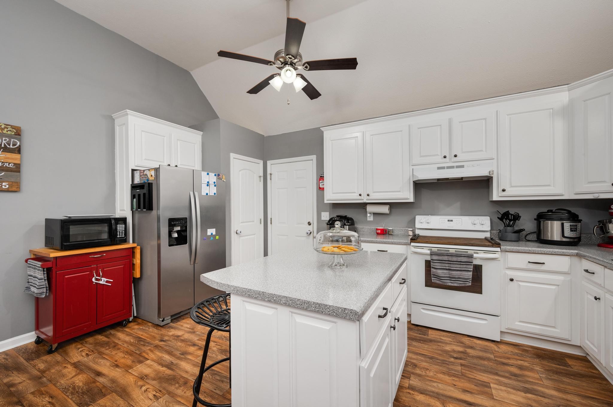 7040 Charity Road Petersburg, TN 37144 - Photo 12 of 36 a kitchen with stainless steel appliances granite countertop a sink stove and refrigerator