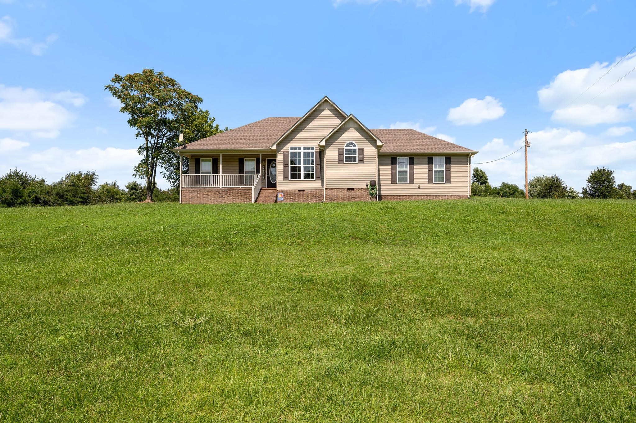 7040 Charity Road Petersburg, TN 37144 - Photo 3 of 36 a front view of a house with garden