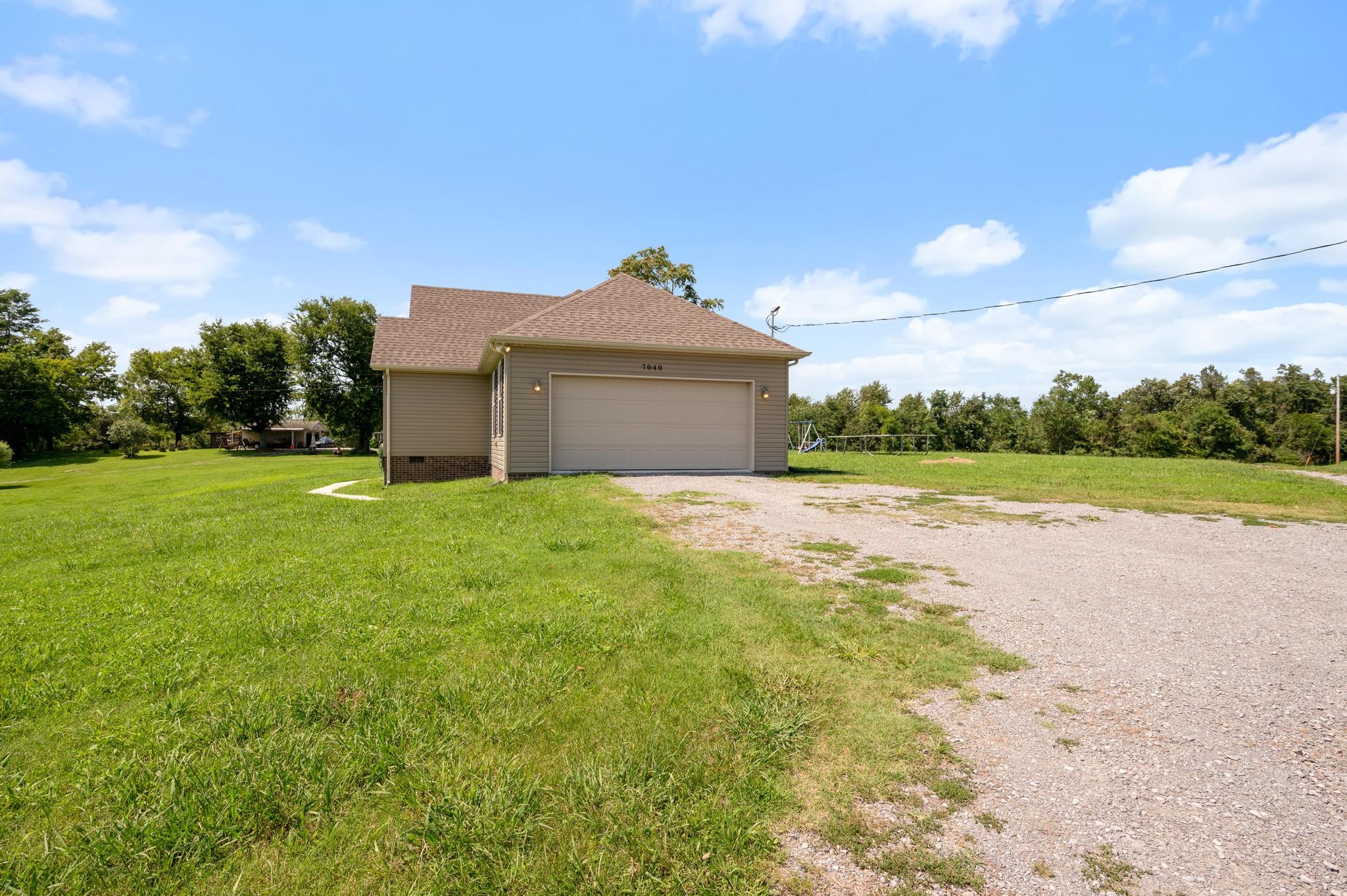 7040 Charity Road Petersburg, TN 37144 - Photo 33 of 36 a view of a big house with a big yard and large trees