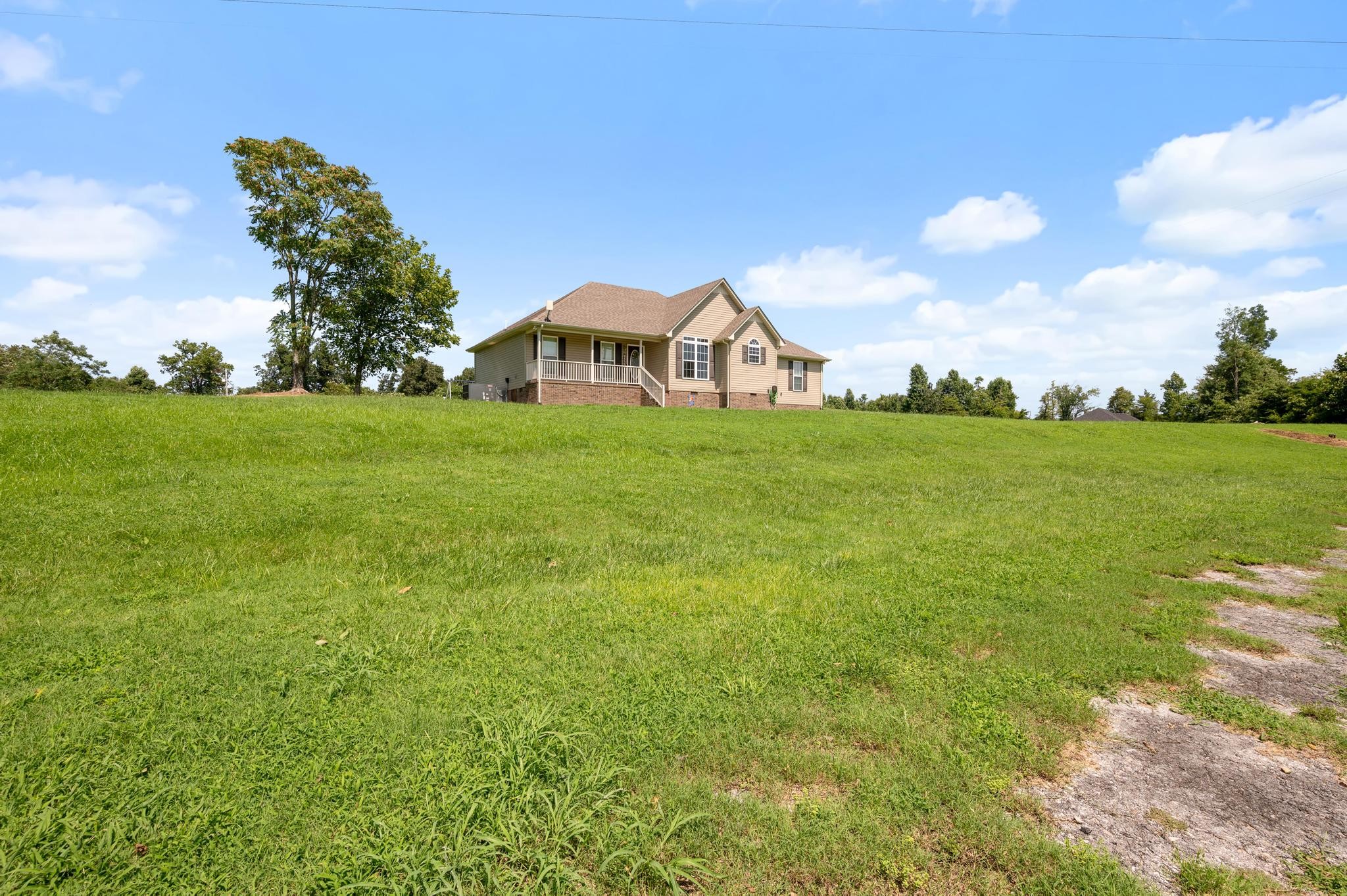 7040 Charity Road Petersburg, TN 37144 - Photo 4 of 36 a view of a big yard with plants and a garden
