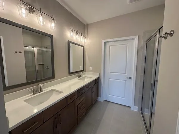 a bathroom with a double vanity sink and mirror