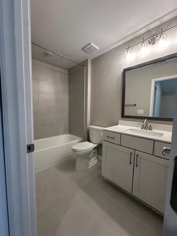 a bathroom with a double vanity sink toilet and shower