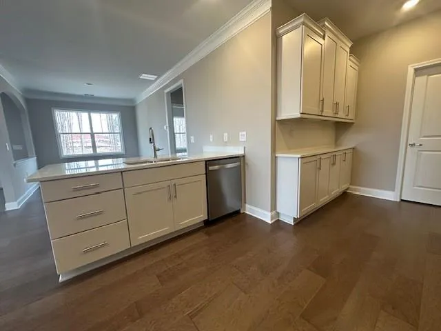 a kitchen with white cabinets and white appliances