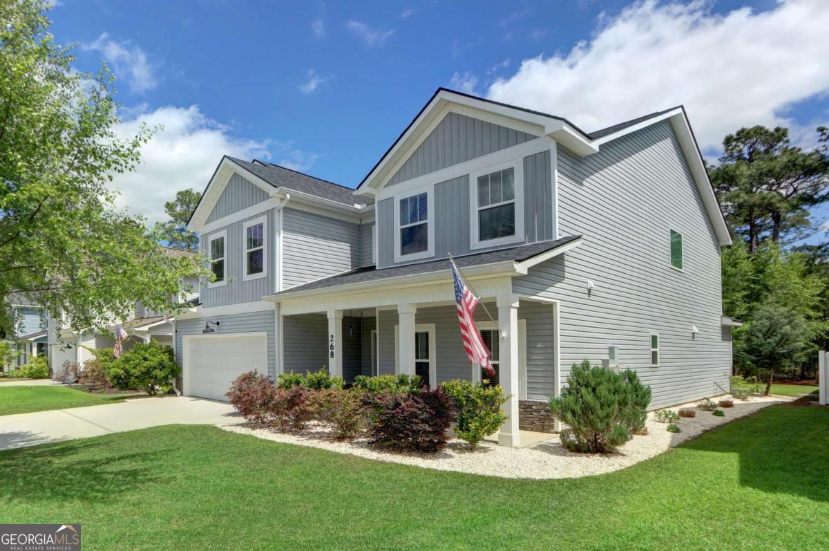 268 Cattle Run Way Pooler, GA 31322 - Photo 1 of 1 a front view of a house with a garden and plants