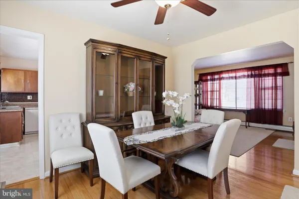 a view of a a dining room with furniture window and wooden floor