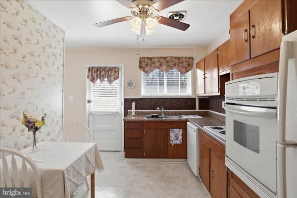 a kitchen with stainless steel appliances granite countertop a stove and a refrigerator
