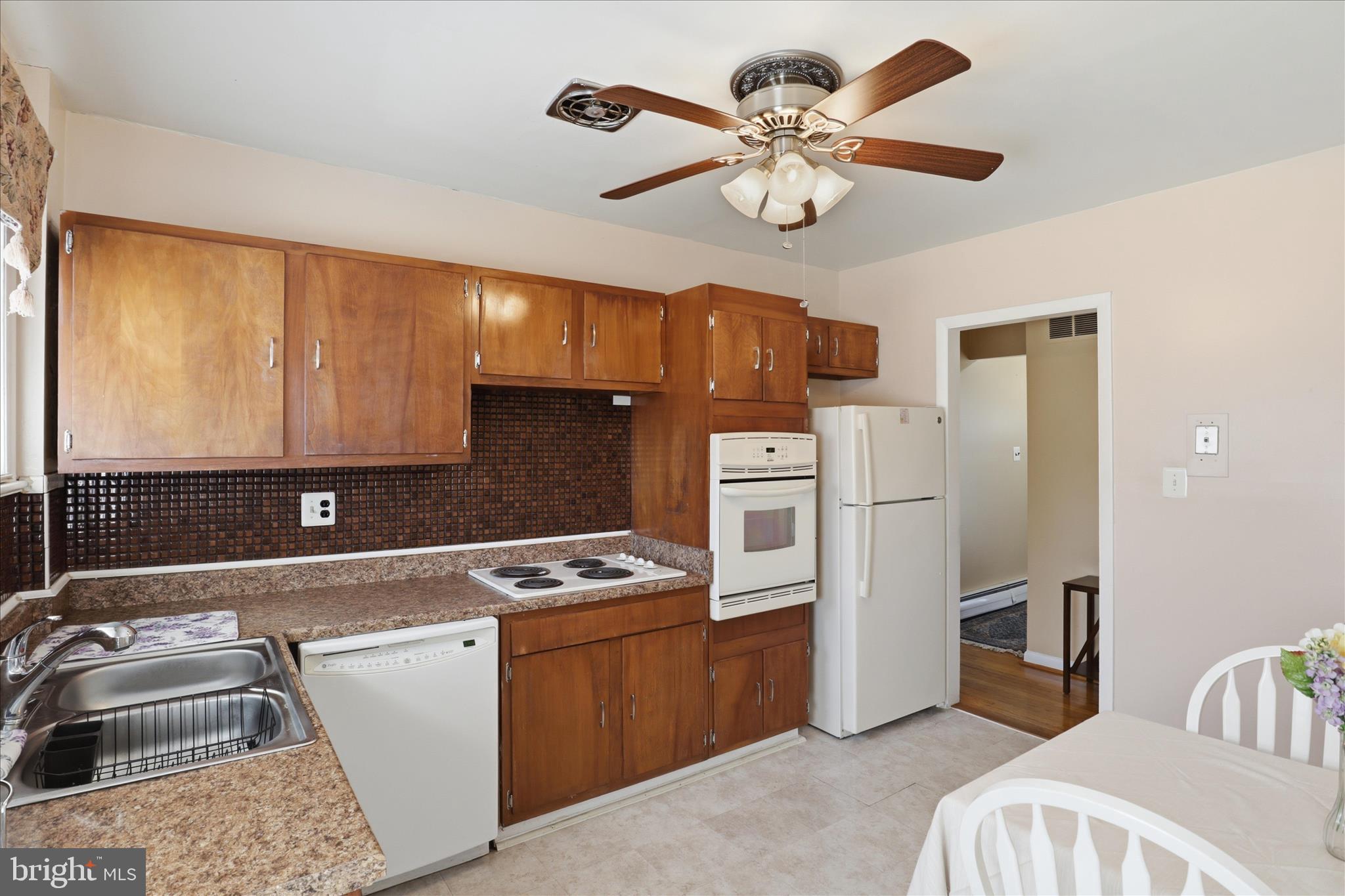 5811 Kirby Road Clinton, MD 20735 - Photo 13 of 43 a kitchen with stainless steel appliances a stove a sink cabinets and a refrigerator