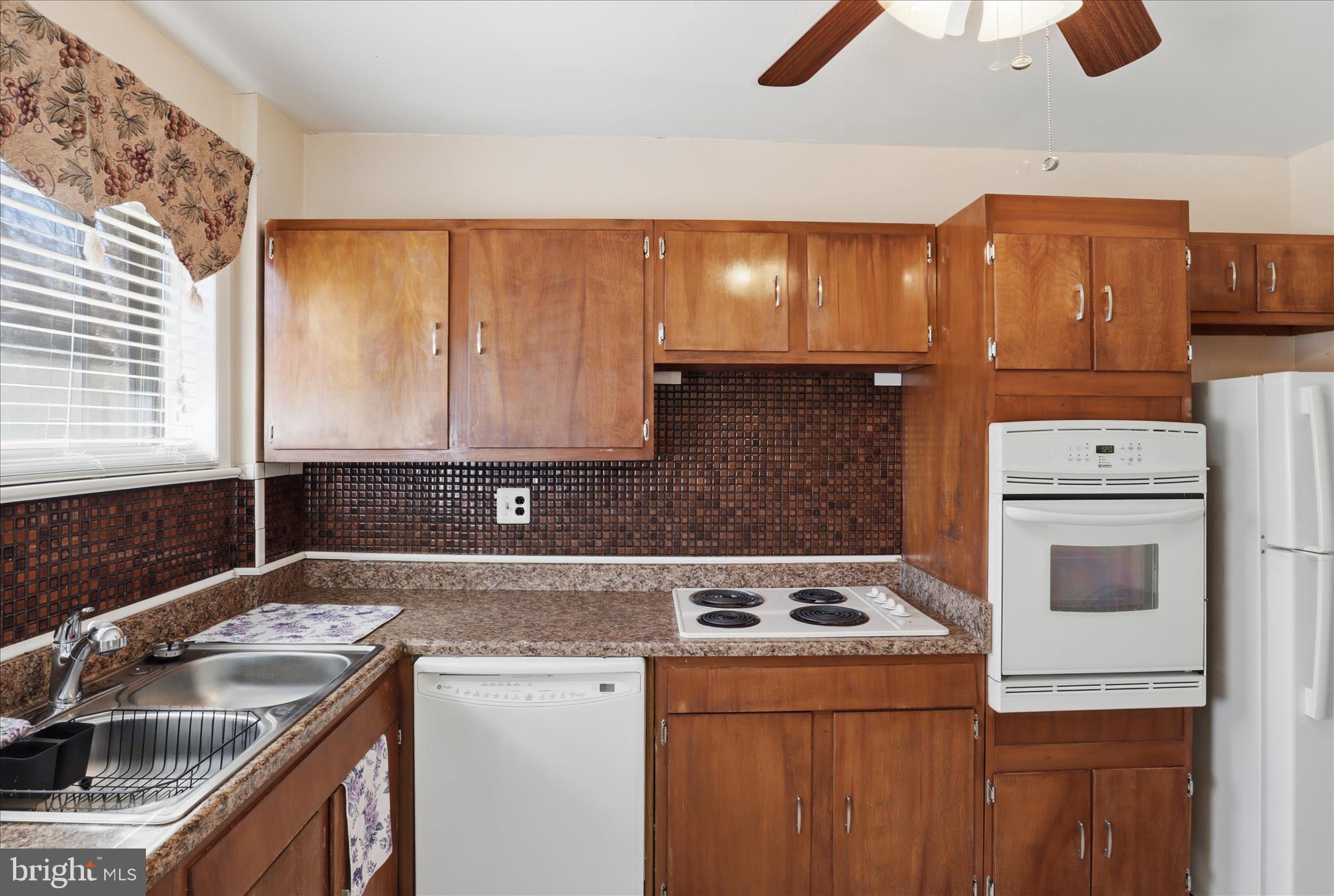 5811 Kirby Road Clinton, MD 20735 - Photo 14 of 43 a kitchen with a sink a stove and cabinets
