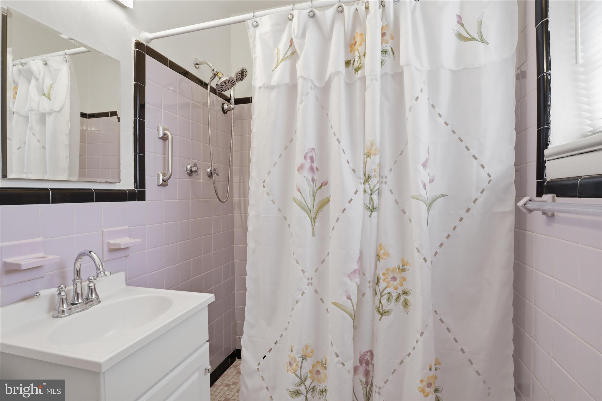 5811 Kirby Road Clinton, MD 20735 - Photo 18 of 43 a bathroom with a shower a sink and a mirror