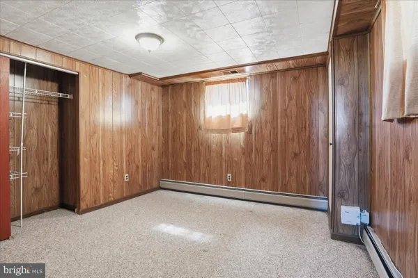 a view of an empty room with wooden walls