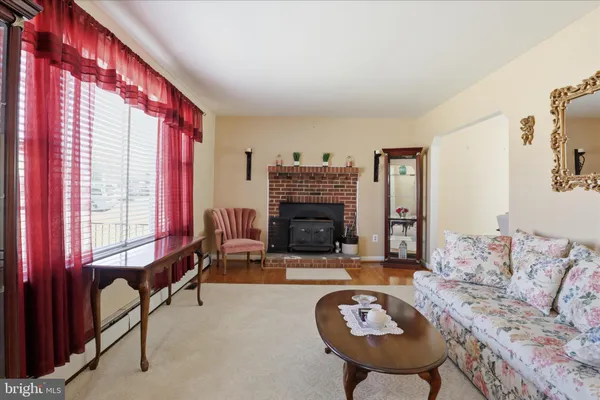 a living room with furniture a fireplace and a large window