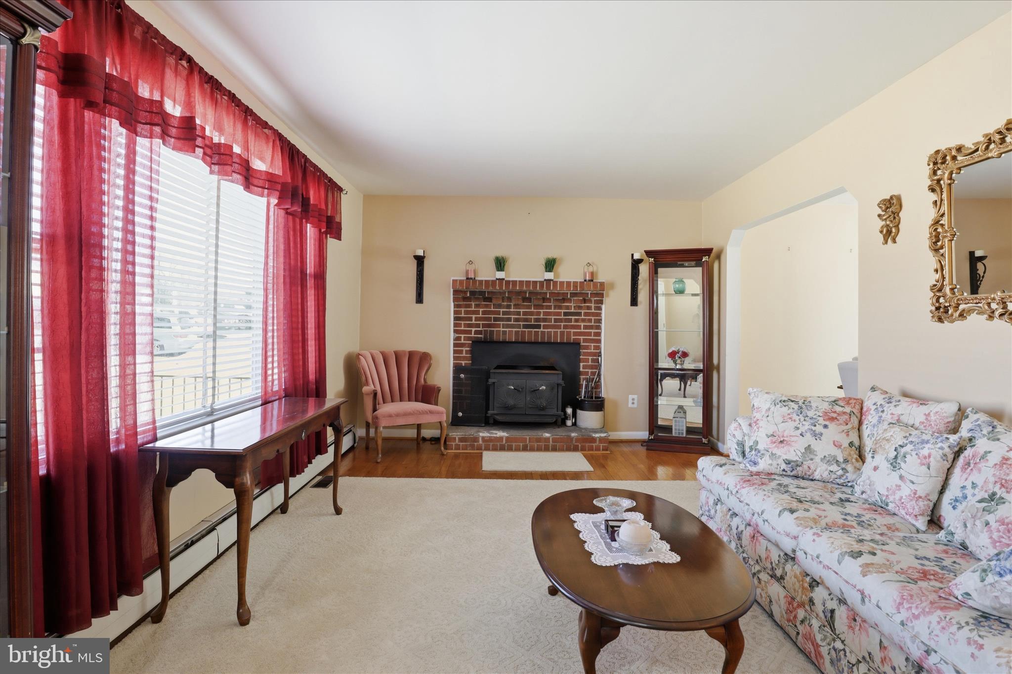 5811 Kirby Road Clinton, MD 20735 - Photo 7 of 43 a living room with furniture a fireplace and a large window