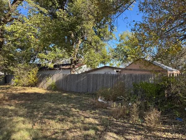 a view of a backyard with large tree
