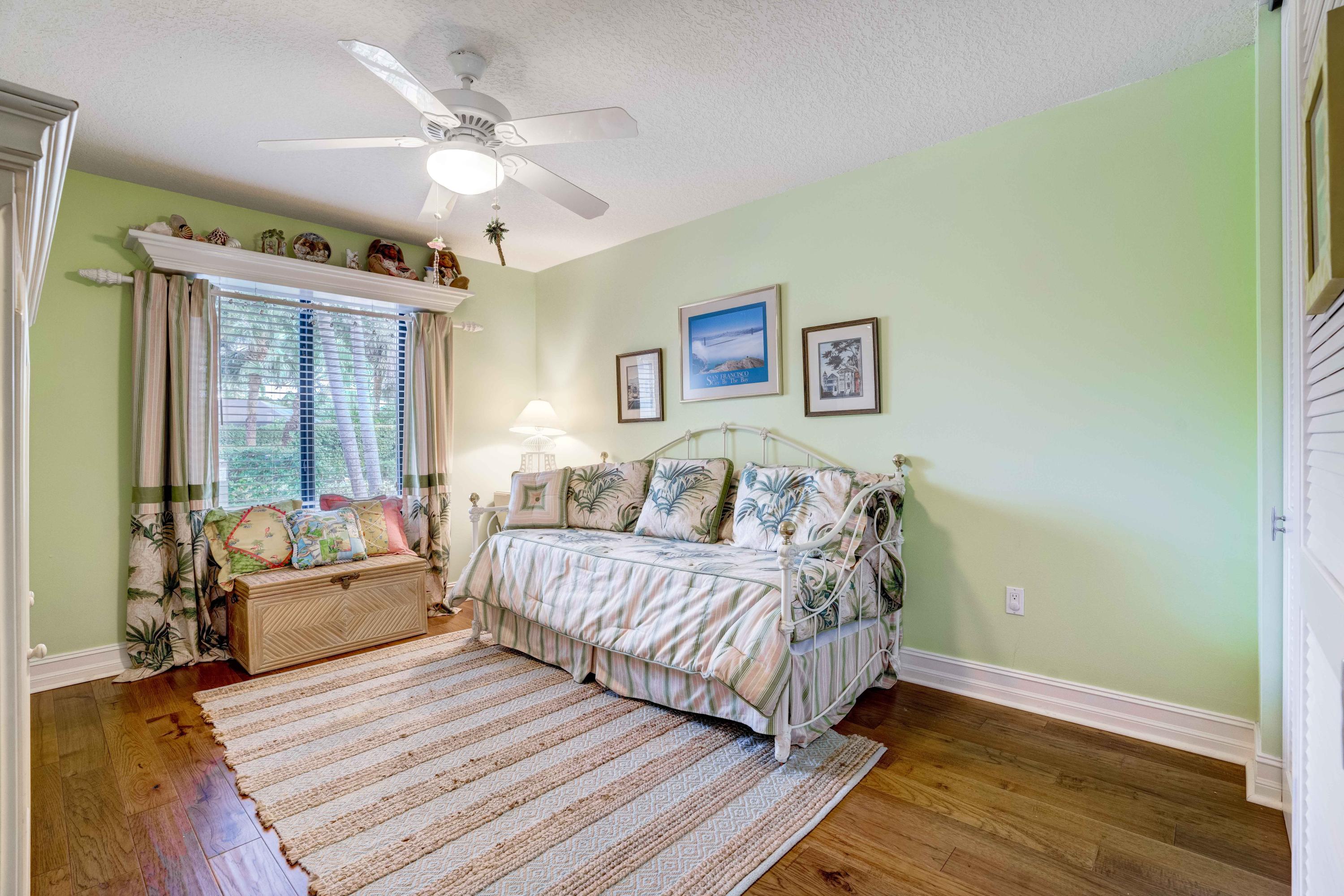 332 River Edge Road Jupiter, FL 33477 - Photo 19 of 103 a spacious bedroom with a bed and a couch