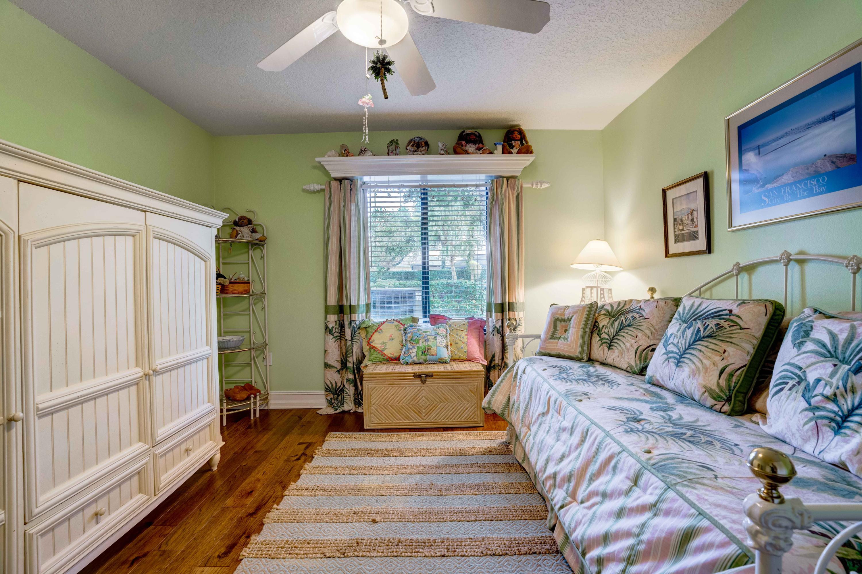 332 River Edge Road Jupiter, FL 33477 - Photo 20 of 103 a spacious bedroom with a large bed and a chandelier
