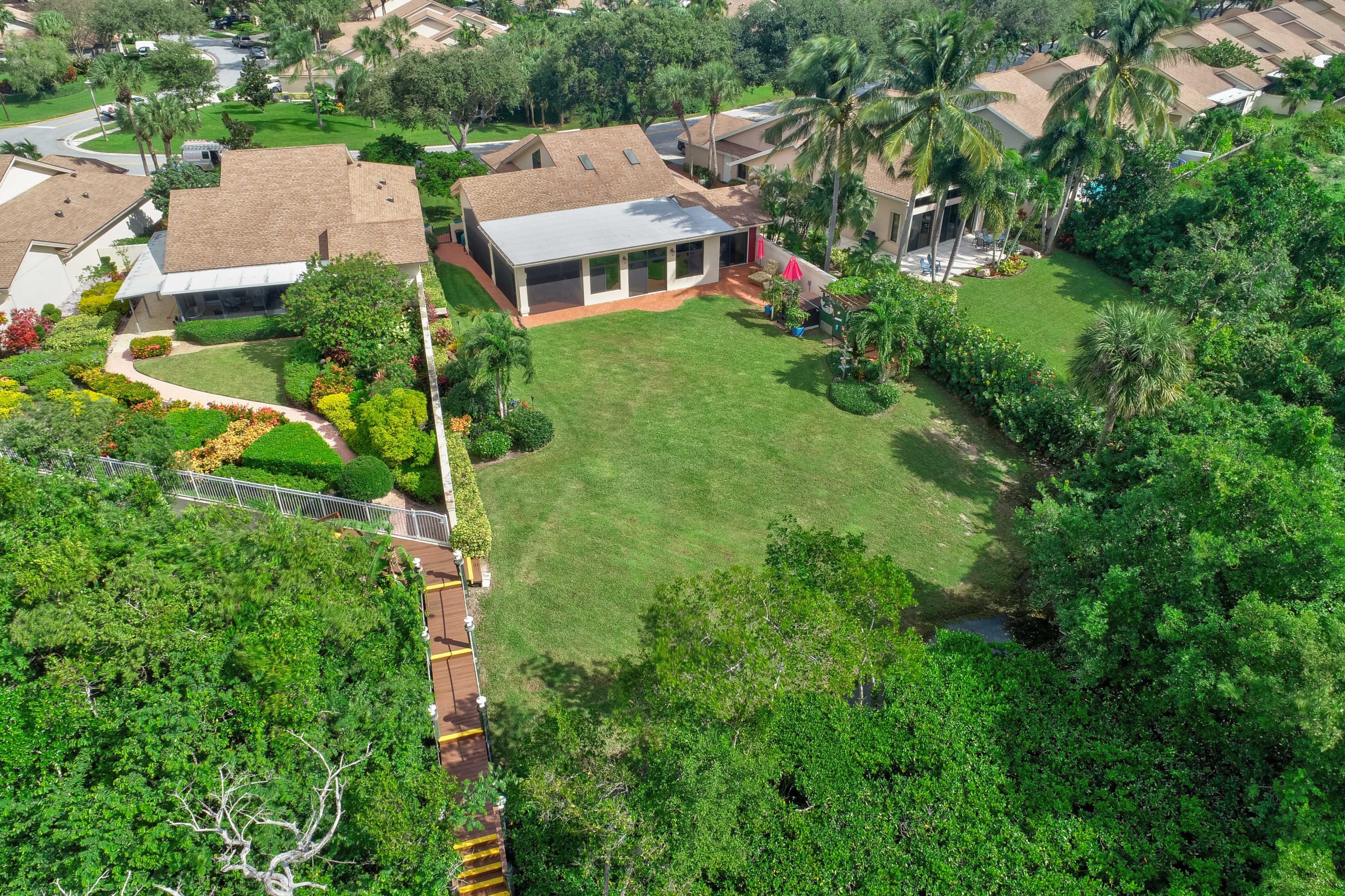 332 River Edge Road Jupiter, FL 33477 - Photo 39 of 103 an aerial view of residential house with outdoor space and trees all around