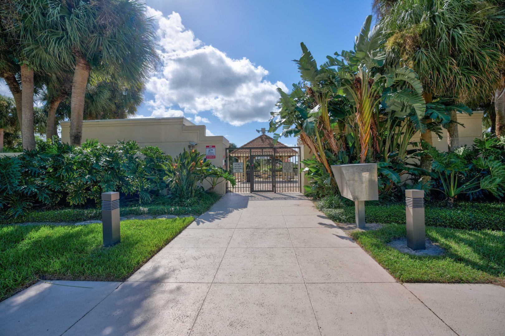 332 River Edge Road Jupiter, FL 33477 - Photo 41 of 103 a front view of a house with garden