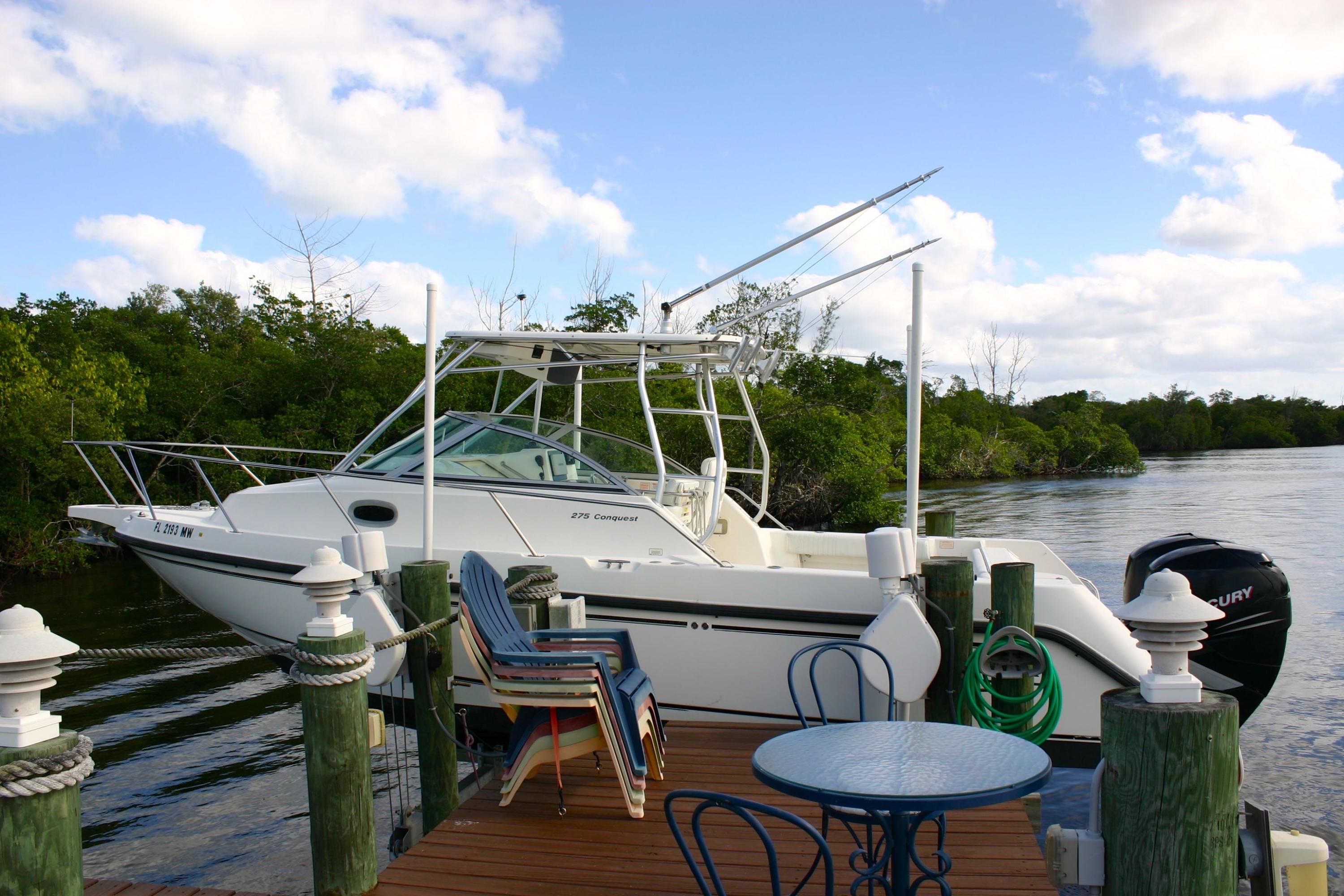 332 River Edge Road Jupiter, FL 33477 - Photo 47 of 103 a view of deck with table and chairs a barbeque with wooden floor and fence