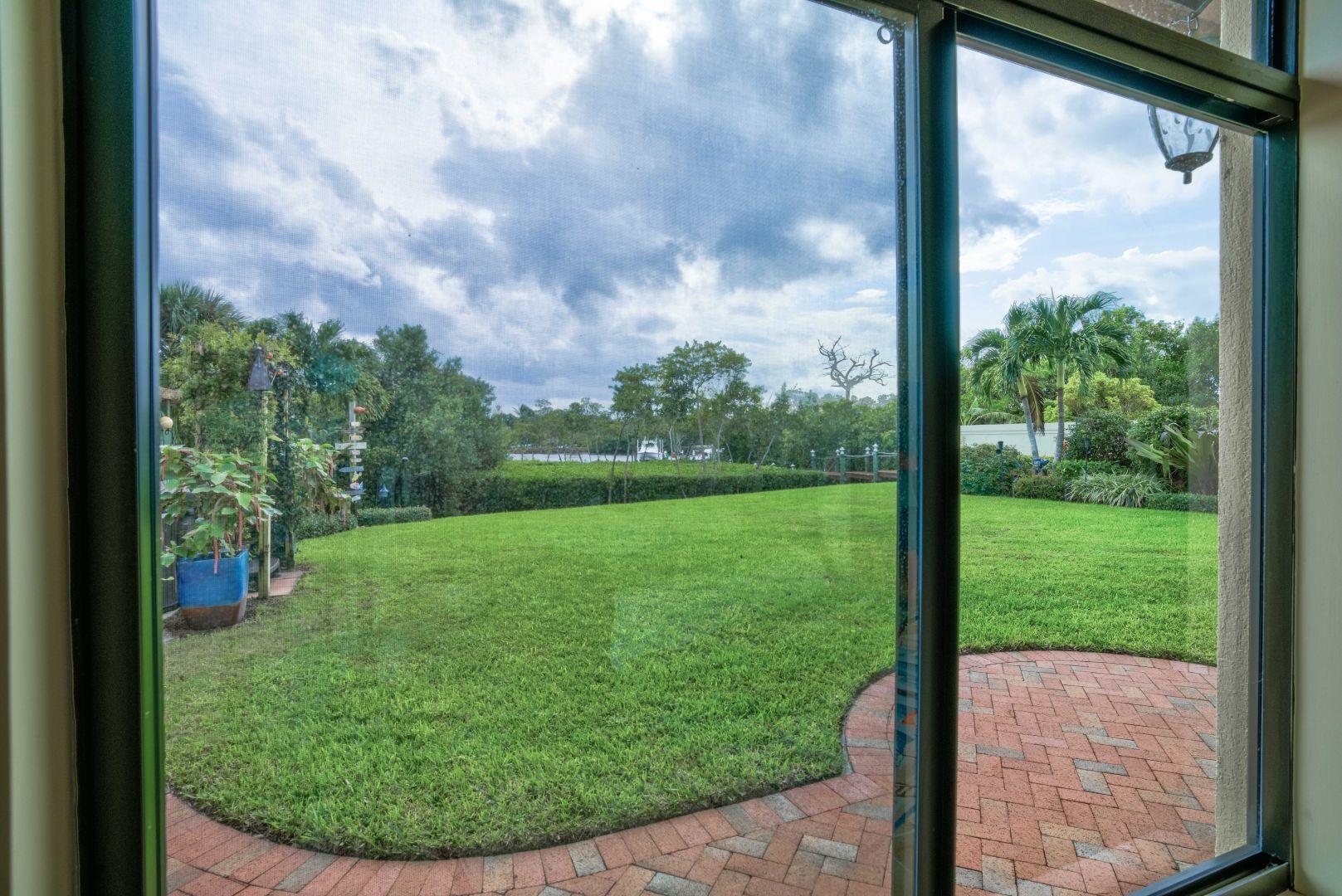 332 River Edge Road Jupiter, FL 33477 - Photo 51 of 103 a view of a yard from a window