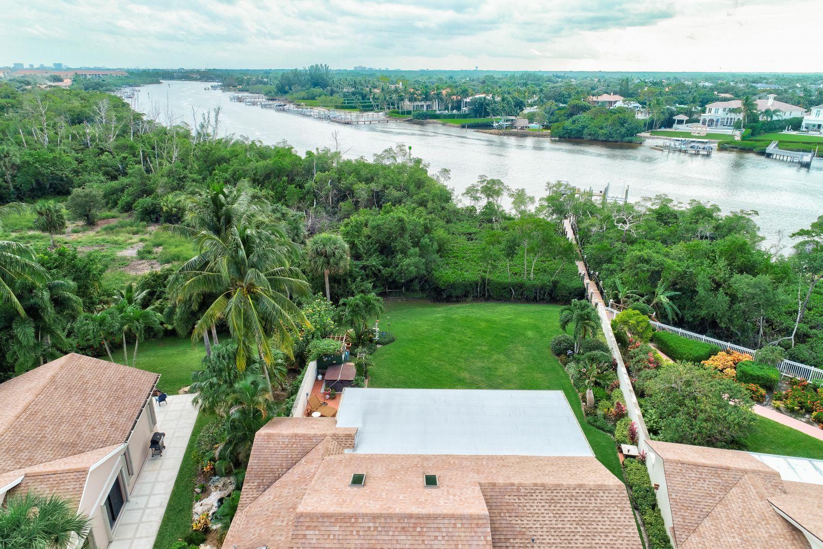 332 River Edge Road Jupiter, FL 33477 - Photo 54 of 103 a view of a lake with houses in the back