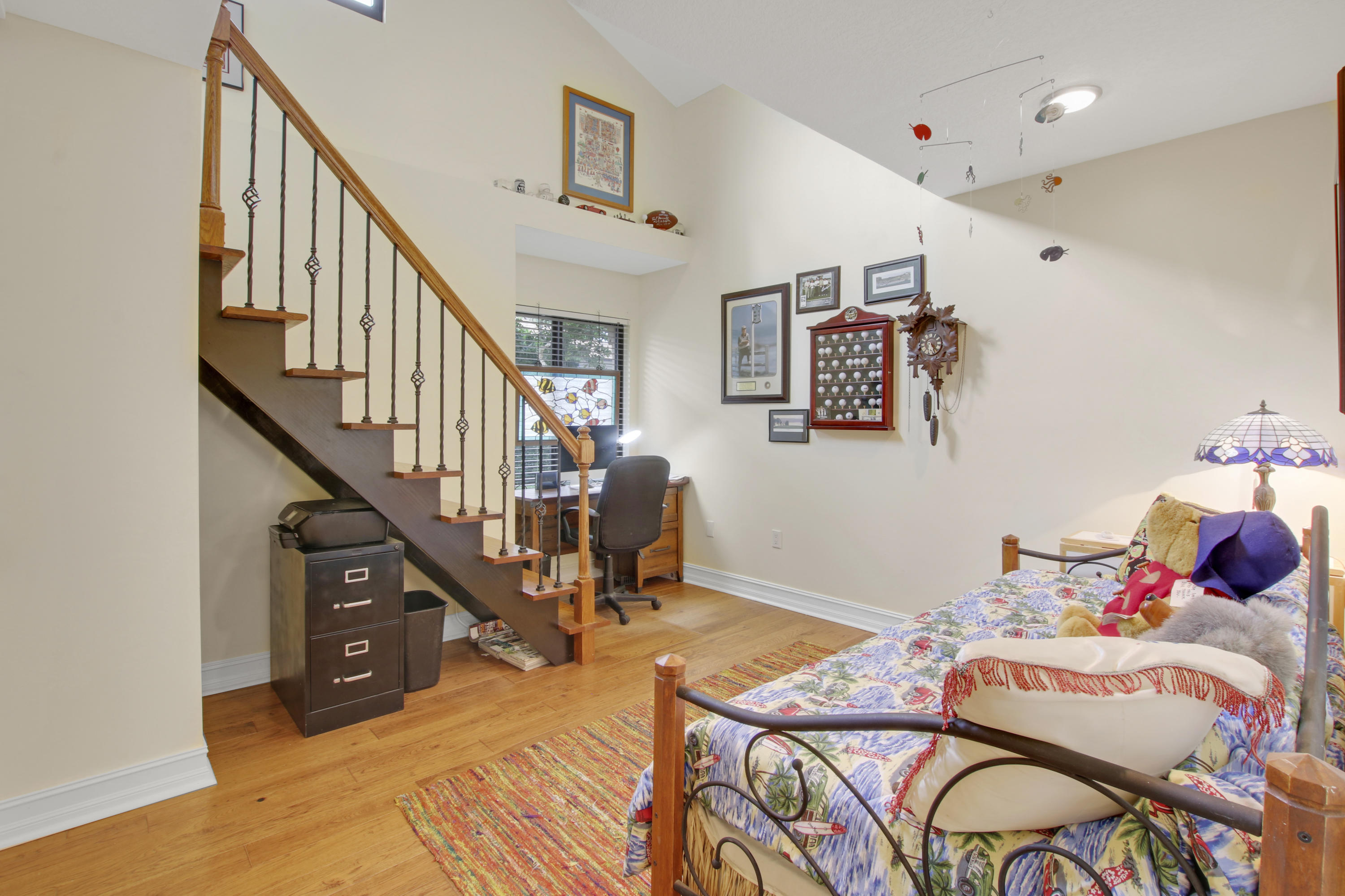 332 River Edge Road Jupiter, FL 33477 - Photo 70 of 103 a bedroom with furniture and a wooden floor