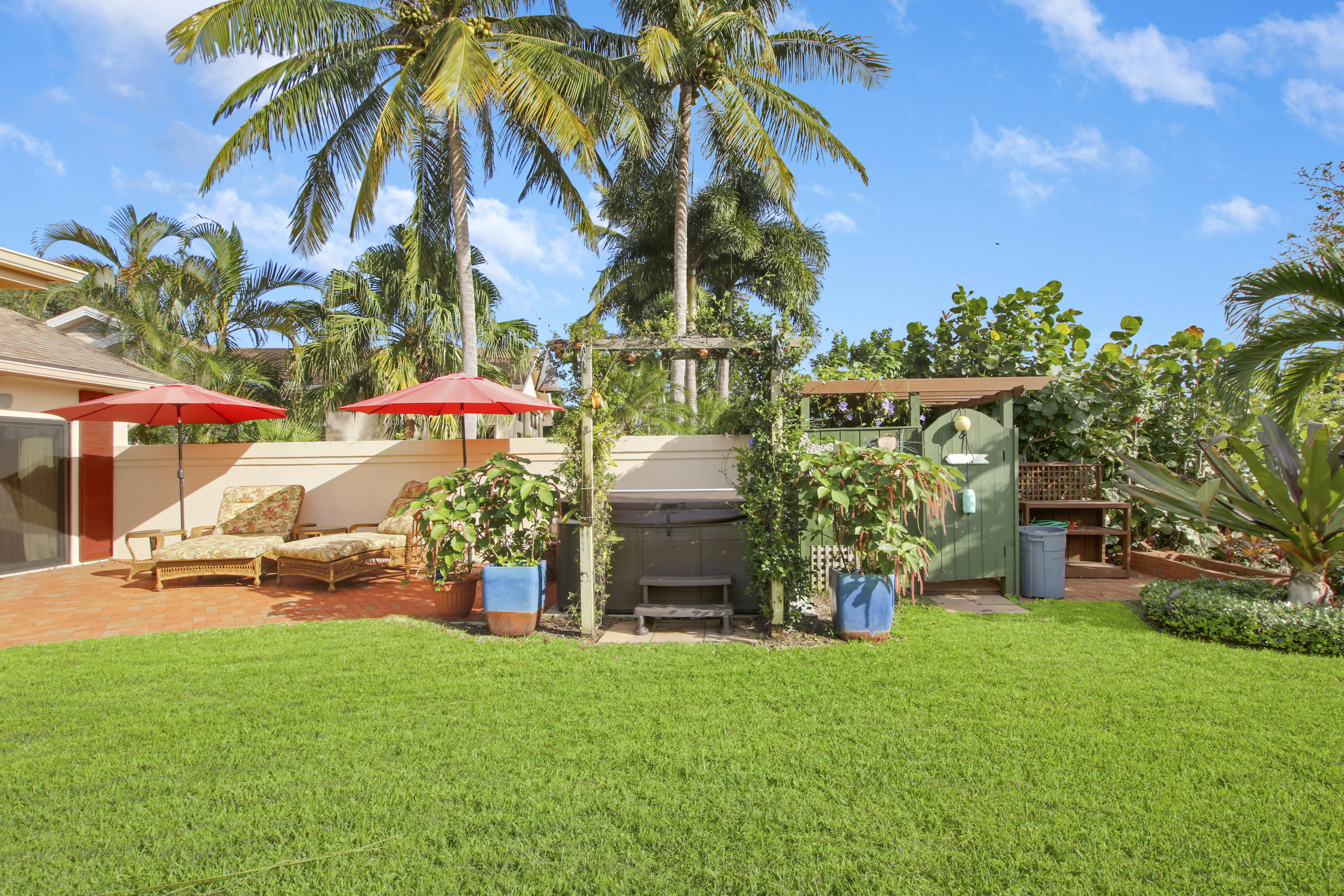 332 River Edge Road Jupiter, FL 33477 - Photo 94 of 103 a front view of a house with garden and sitting area