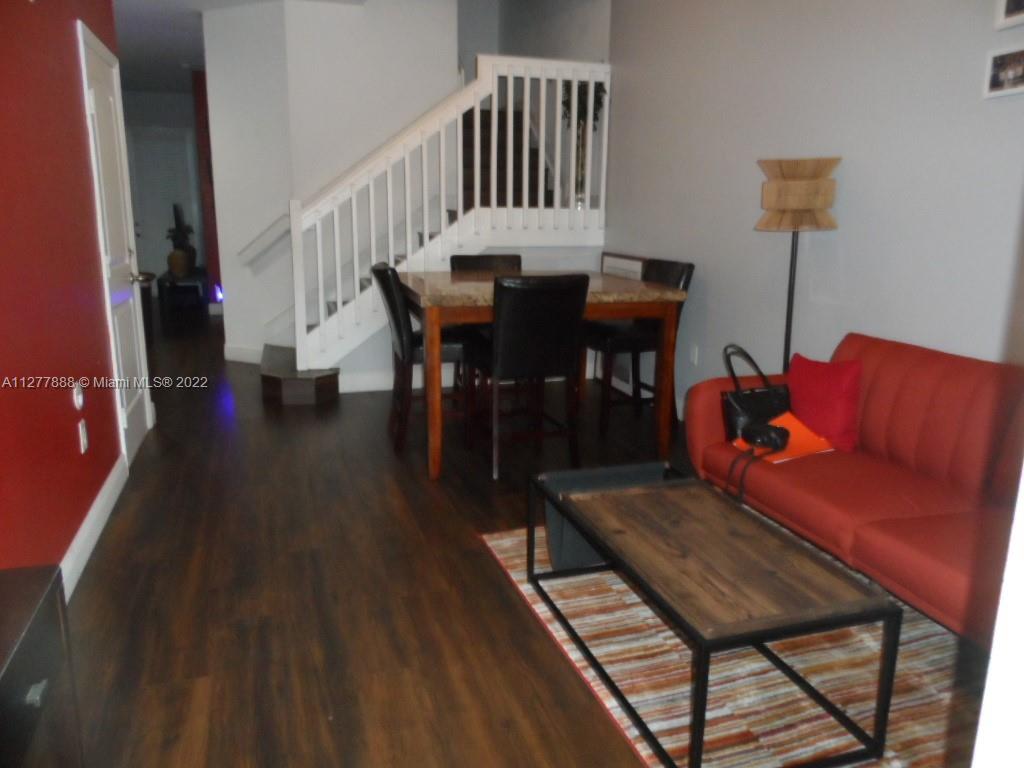 Walden Miami Gardens, FL 33169 - Photo 5 of 7 a view of a dining room with furniture and wooden floor