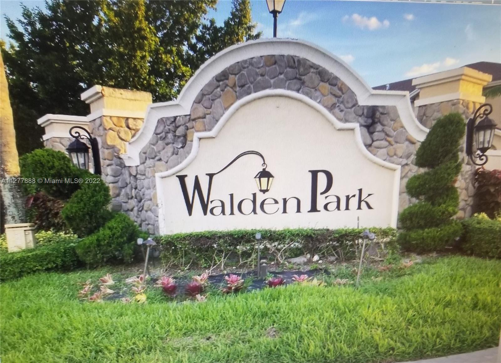 Walden Miami Gardens, FL 33169 - Photo 7 of 7 a sign that is on a brick wall