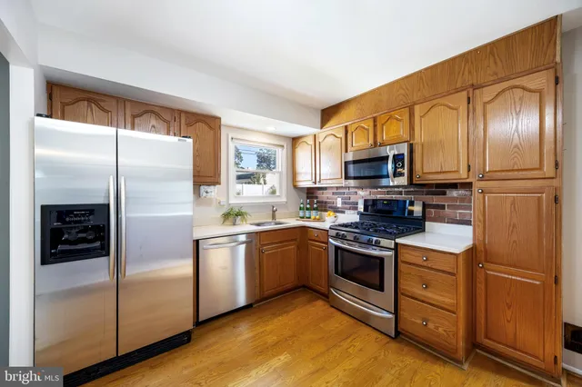 a kitchen with stainless steel appliances granite countertop a refrigerator stove and kitchen