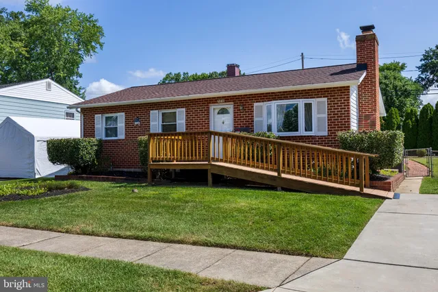 a view of a house with a yard and a deck