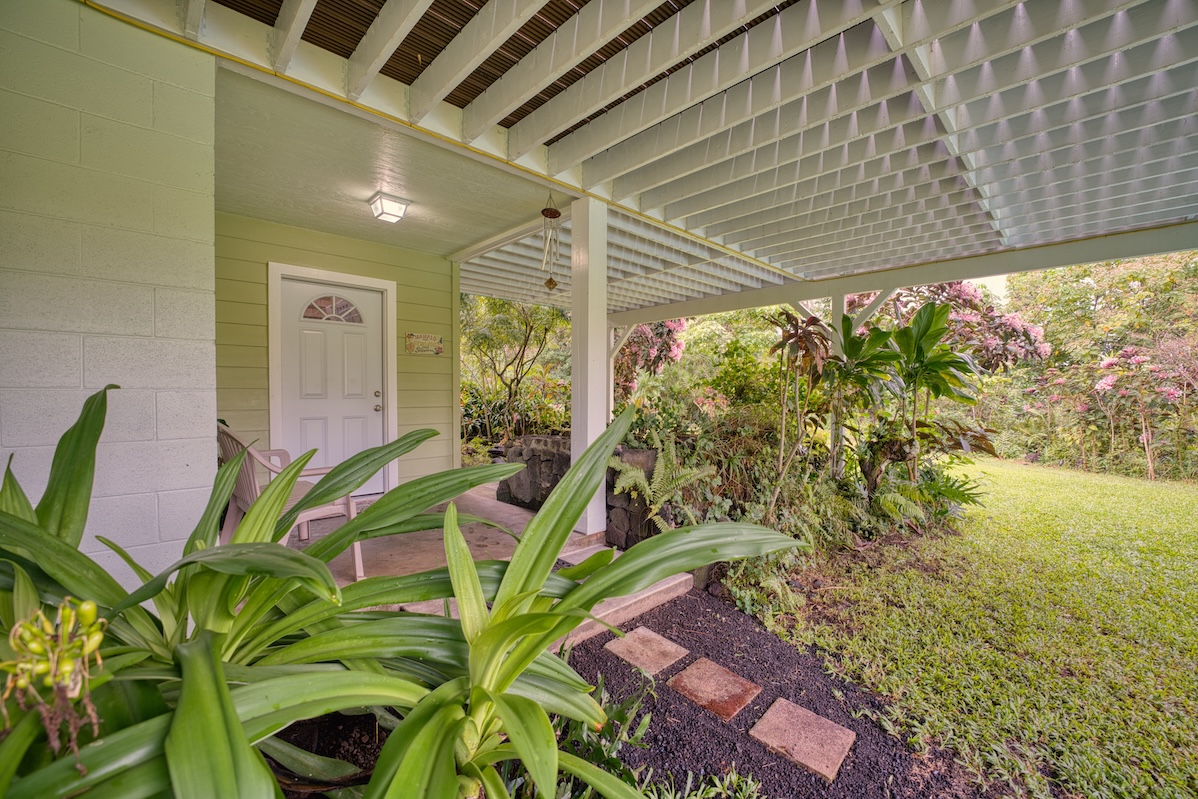 14-3674 Government Beach Road Pahoa, HI 96778 - Photo 22 of 29 a backyard of a house with lots of green space and glass windows