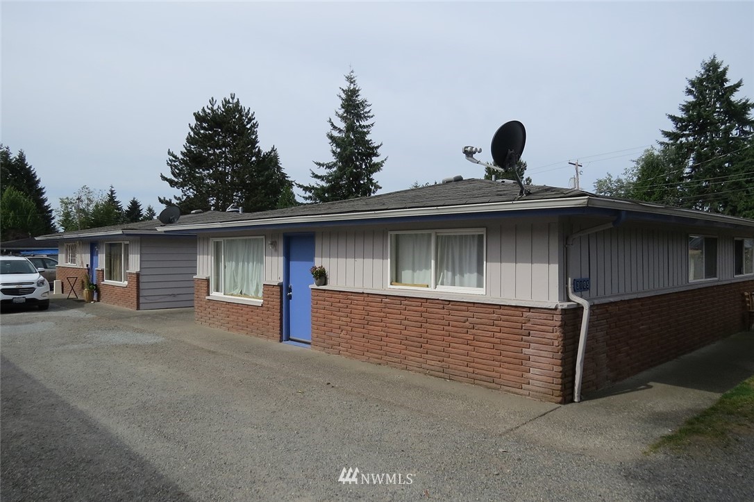 3105 Northeast 15th Street Renton, WA 98056 - Photo 1 of 2 a view of a house with large parking space and a car parked on road