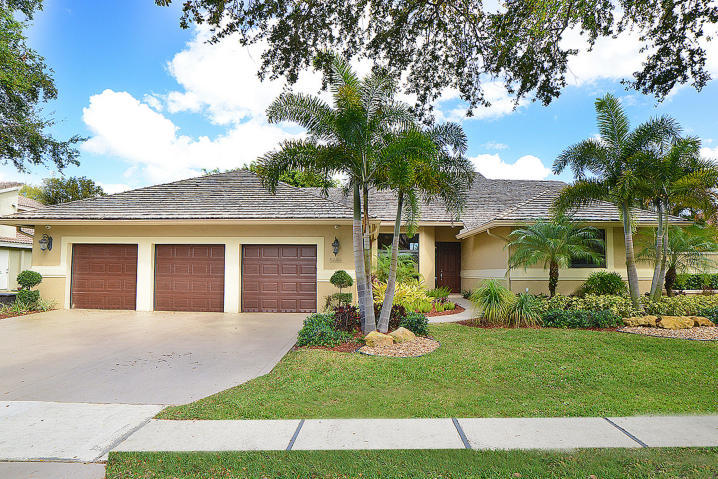 5686 St Annes Way Boca Raton, FL 33496 - Photo 1 of 18 a front view of a house with a garden and yard