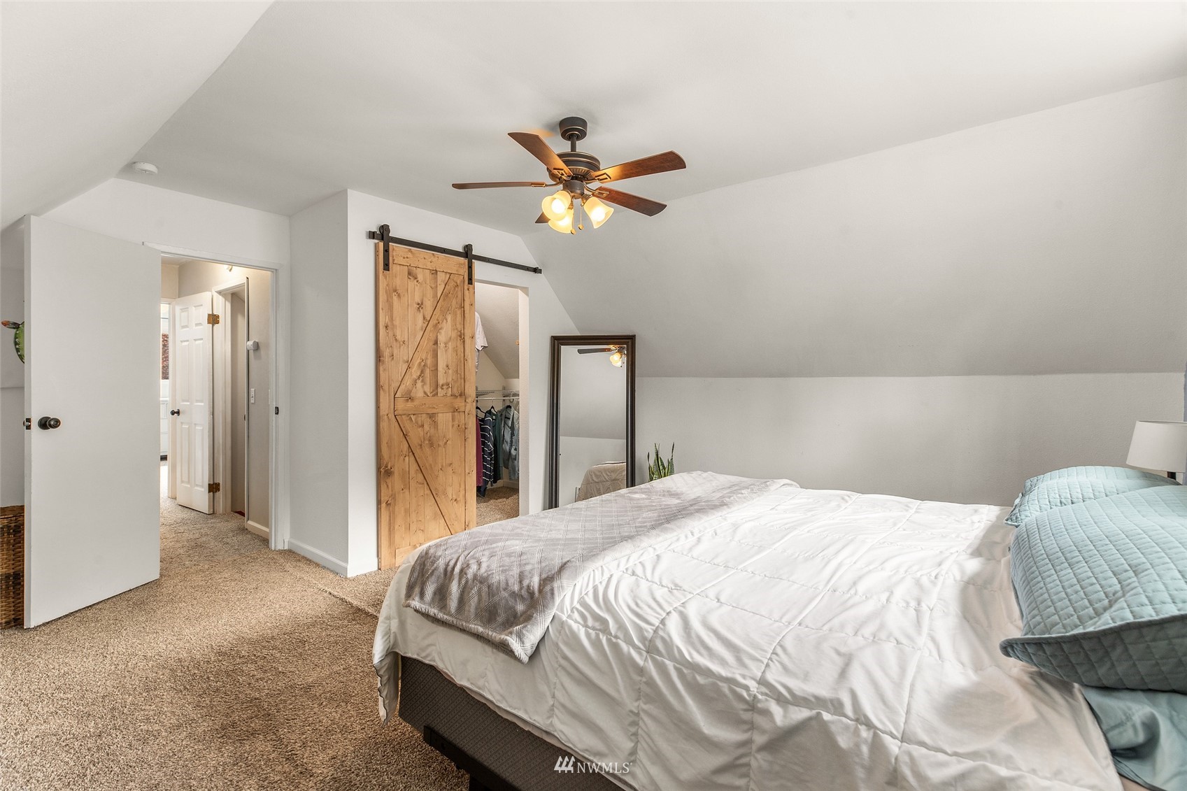 14627 Southeast 140th Street Renton, WA 98059 - Photo 19 of 33 a bedroom with a bed and a chandelier
