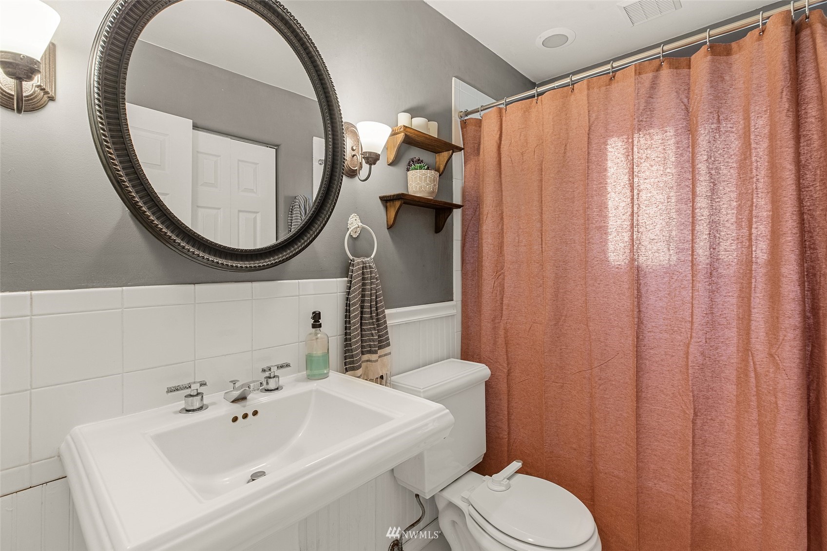 14627 Southeast 140th Street Renton, WA 98059 - Photo 24 of 33 a bathroom with a sink a mirror and a toilet