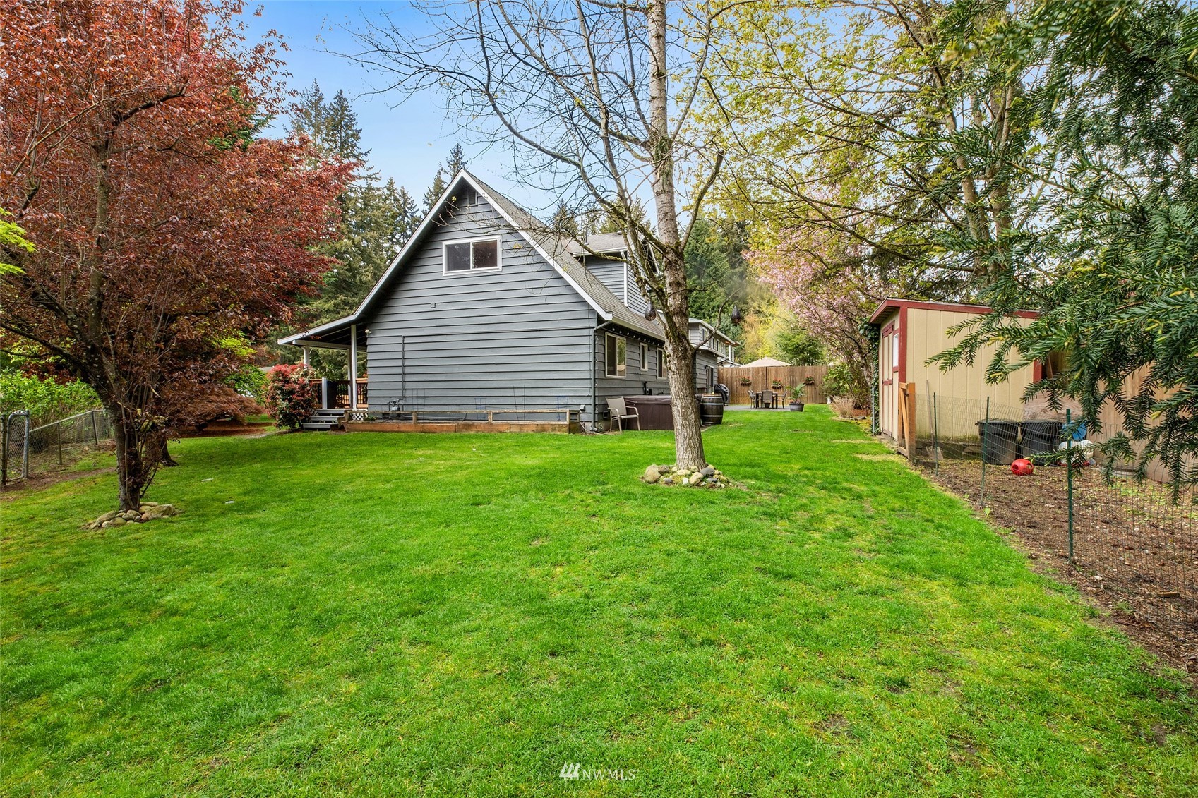 14627 Southeast 140th Street Renton, WA 98059 - Photo 27 of 33 a backyard of a house with plants and large tree