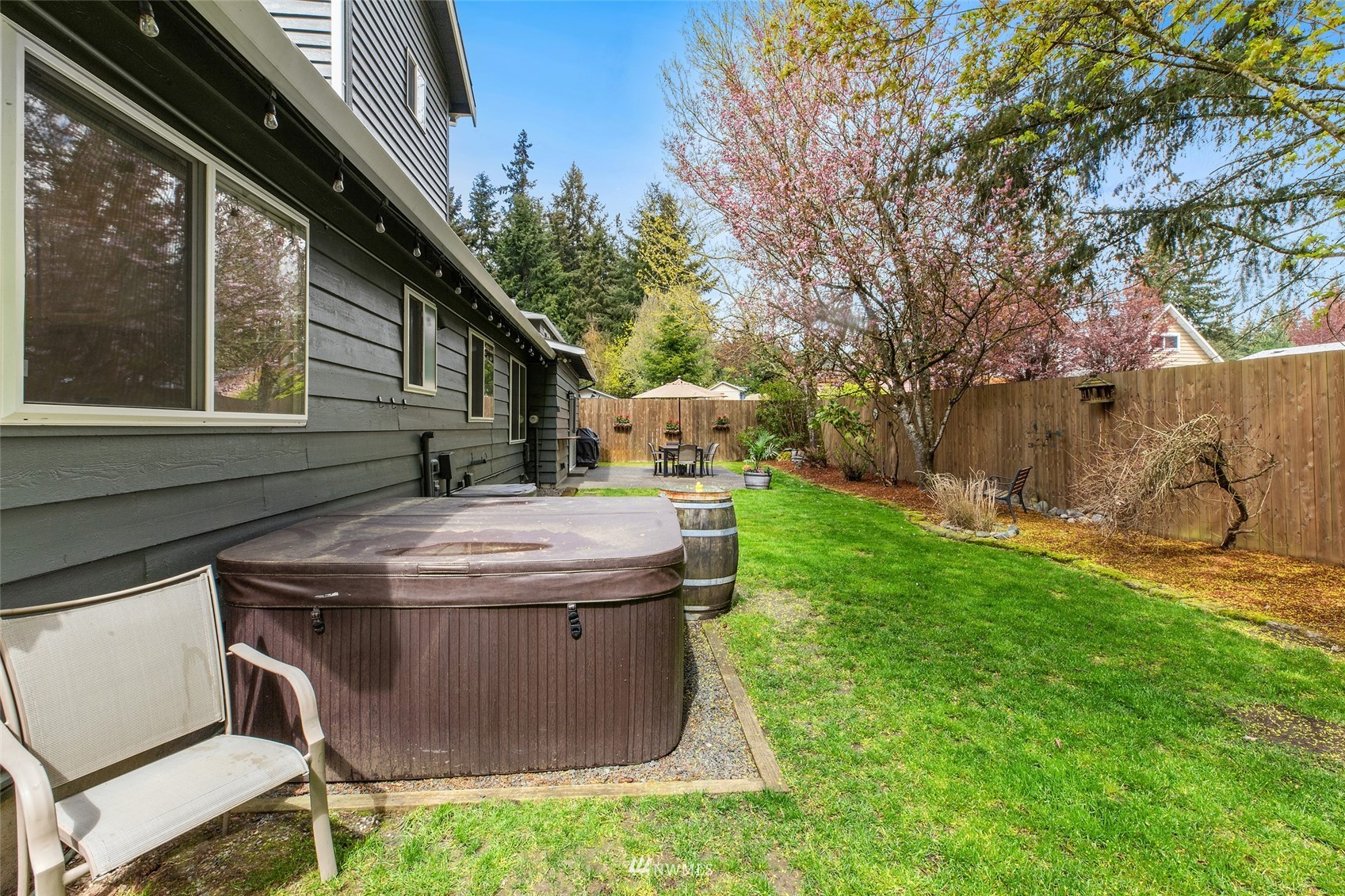 14627 Southeast 140th Street Renton, WA 98059 - Photo 29 of 33 a view of a backyard with table and chairs and a large tree